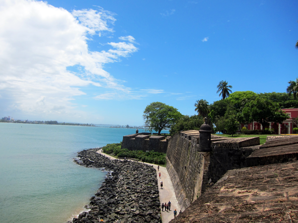 Walkway along the walls of Old San Juan with a view of the Bacardi Factory in the distance