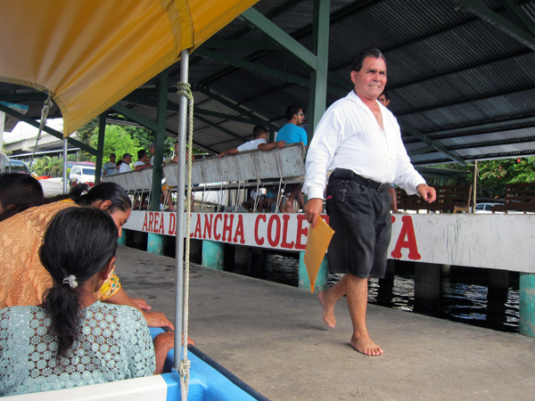 Boarding a Lancha (motorboat) to cruise up Rio Dulce to Livingston