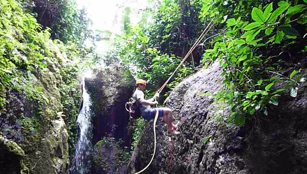 Rappelling down a waterfall in El Toro Negro Rainforest in Puerto Rico