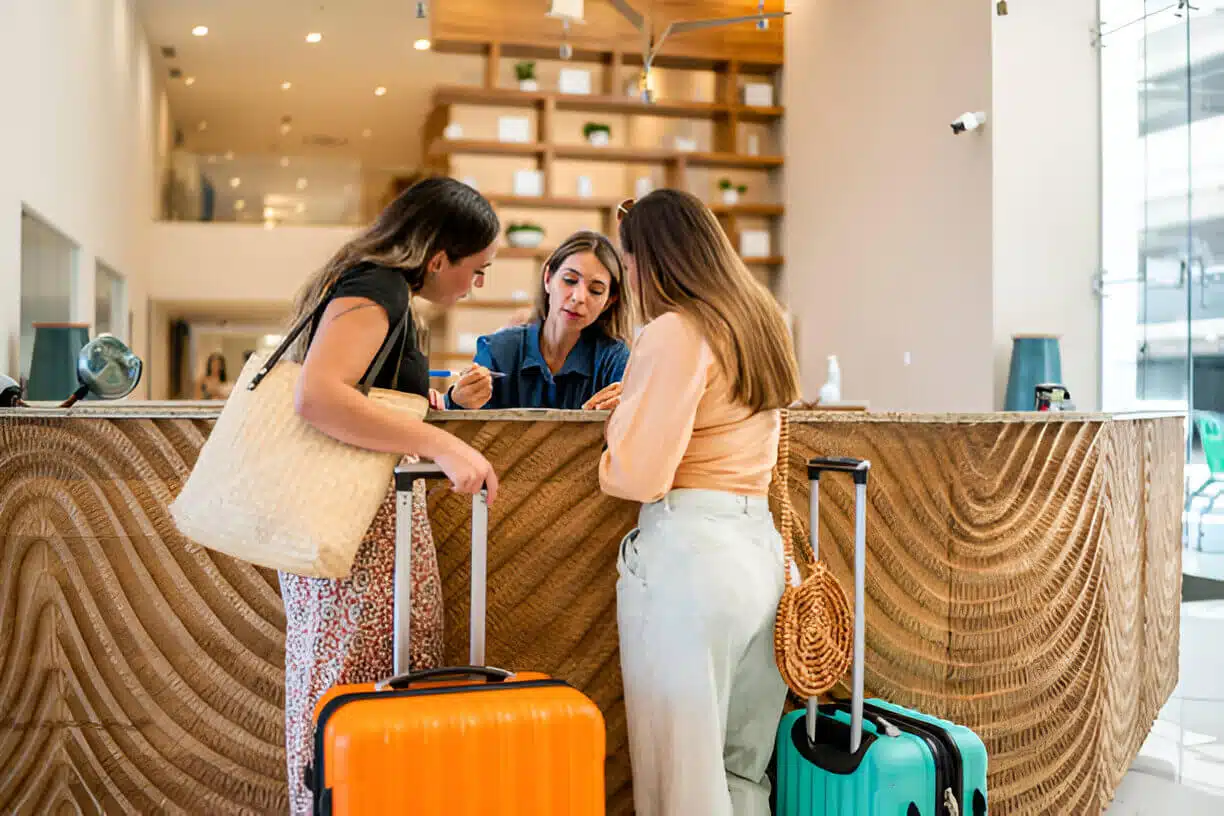 Hotel receptionist talking customers at lobby